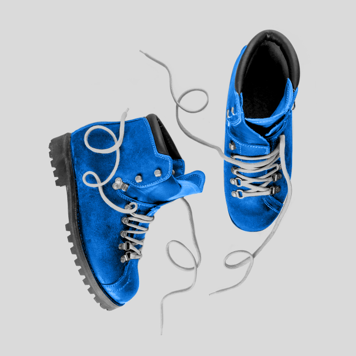 A pair of hiking boots, tinted blue